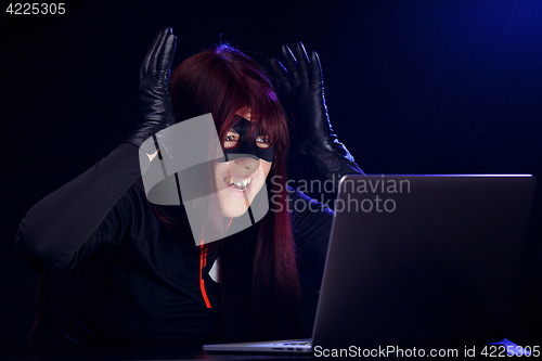 Image of Surprised night hacker by laptop