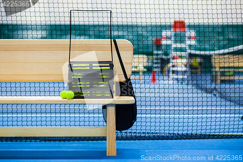 Image of Close up view of tennis court through the net