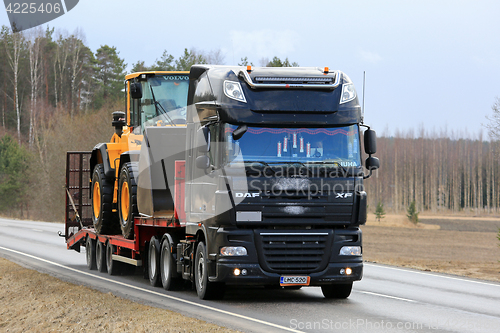 Image of Black DAF XF Semi Truck Hauls Wheel Loader