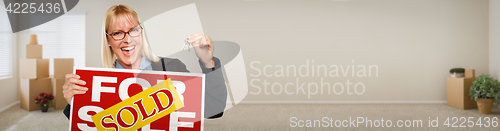 Image of Banner of Adult Woman Inside Room with Boxes Holding House Keys 