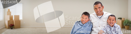 Image of Young Hispanic Father and Sons Family Inside Room with Boxes Ban