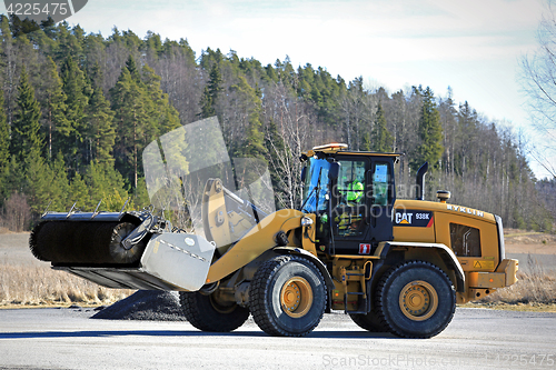 Image of Cat Wheel Loader Bucket Sweeper Cleans Yard