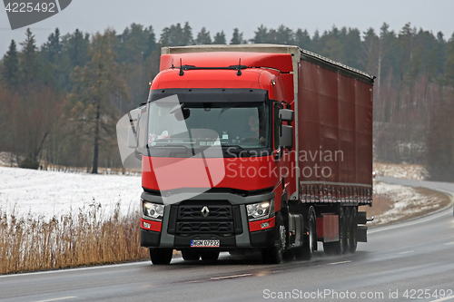 Image of Red Renault Trucks T Semi Hauls Cargo in Winter