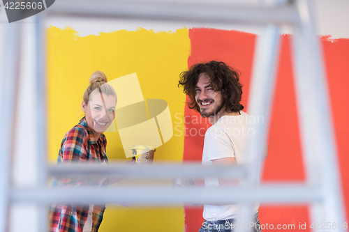 Image of couple painting interior wall