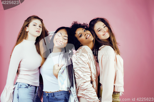 Image of three different nation girls with diversuty in skin, hair. Asian, scandinavian, african american cheerful emotional posing on pink background, woman day celebration, lifestyle people concept 