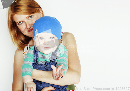 Image of young beauty mother with cute baby, red head happy modern family