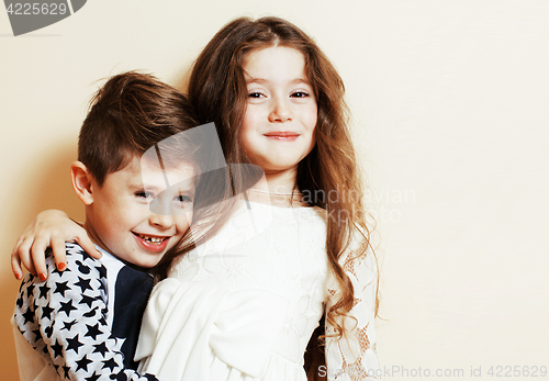 Image of little cute boy and girl hugging playing on white background, ha