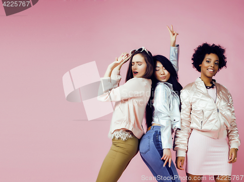 Image of different nation girls with diversuty in skin, hair. Asian, scandinavian, african american cheerful emotional posing on pink background, woman day celebration, lifestyle people concept 