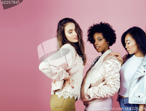 Image of different nation girls with diversuty in skin, hair. Asian, scandinavian, african american cheerful emotional posing on pink background, woman day celebration, lifestyle people concept 