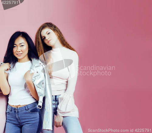 Image of different nation girls with diversuty in skin, hair. Asian, scandinavian, african american cheerful emotional posing on pink background, woman day celebration, lifestyle people concept 