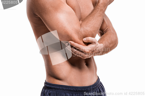 Image of Man With Pain In Elbow. Pain relief concept
