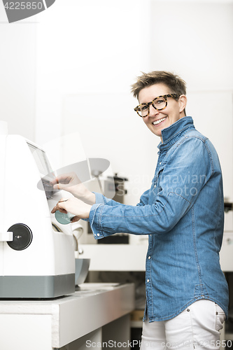 Image of woman hone the edge of the eyeglasses