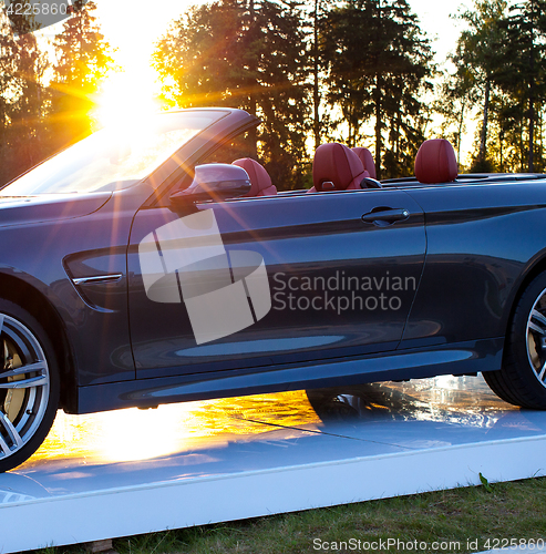 Image of cabriolet car and the sun