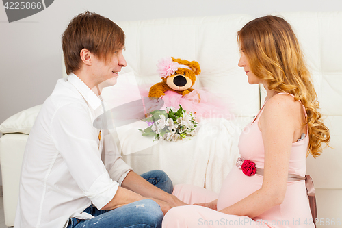 Image of Man and pregnant woman sitting face to face