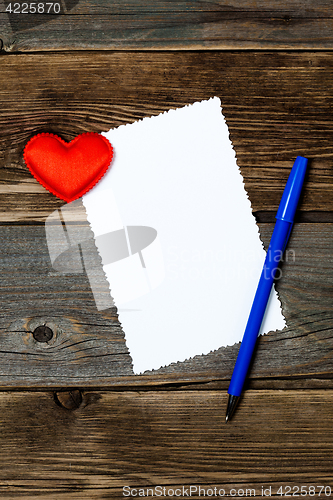 Image of valentines day. empty blank, blue pen and red heart