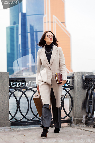 Image of beautiful business woman in a bright coat