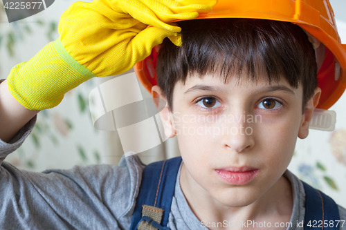 Image of Boy wearing a protective helmet and gloves