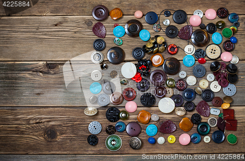 Image of Old buttons on the wooden boards