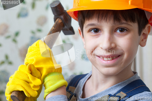 Image of Boy in the image of a builder with a hammer in his hands