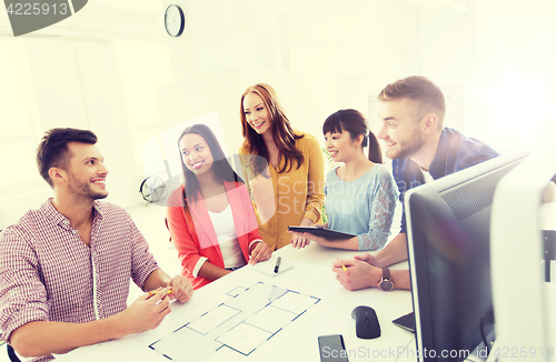 Image of happy creative team or students working at office