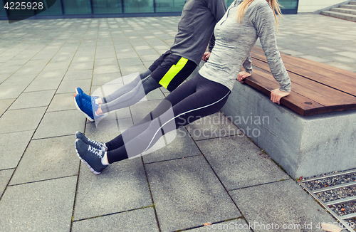 Image of close up of couple doing triceps dip on bench