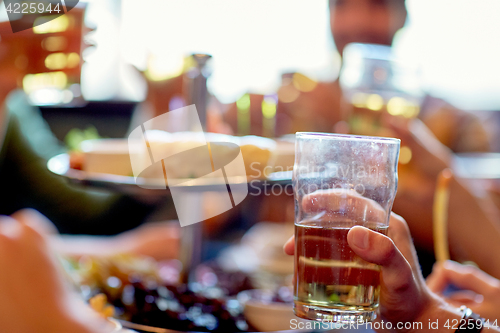 Image of friends drinking beer at bar or pub
