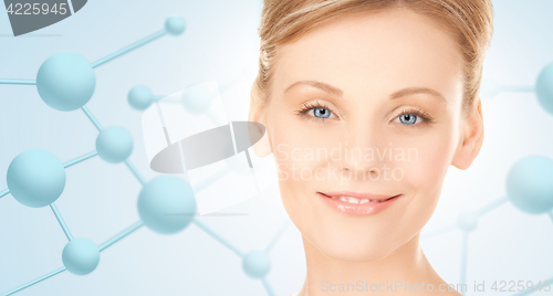 Image of beautiful young woman face with molecules