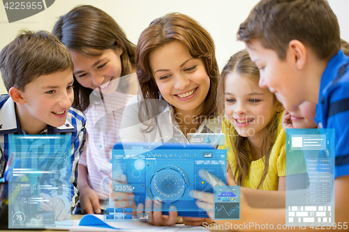 Image of group of kids with teacher and tablet pc at school