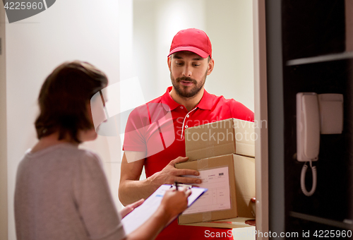 Image of deliveryman and customer with parcel boxes at home