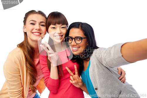 Image of international group of happy women taking selfie