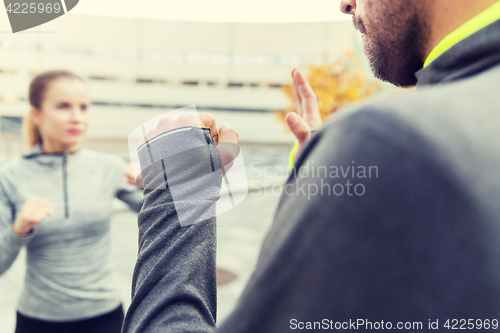 Image of close up of woman with trainer working strike out