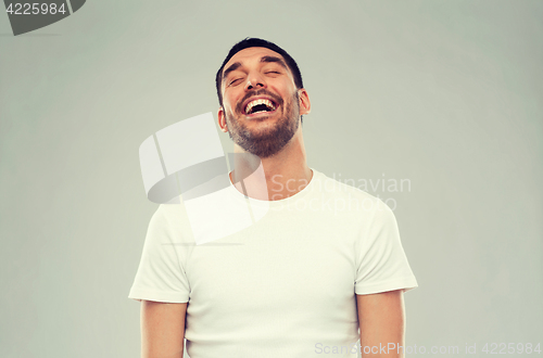 Image of laughing man over gray background