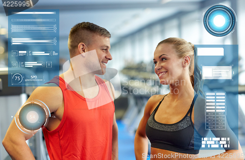 Image of smiling man and woman talking in gym