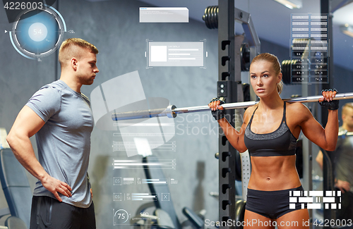 Image of man and woman with barbell flexing muscles in gym