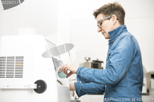 Image of woman hone the edge of the eyeglasses