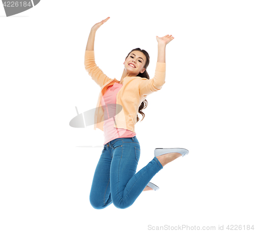 Image of smiling young woman jumping in air