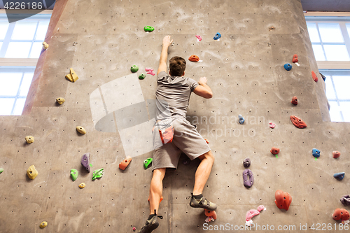 Image of young man exercising at indoor climbing gym