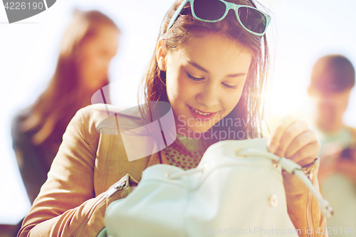 Image of high school student girl with backpack outdoors