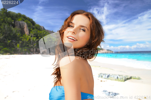 Image of happy woman in bikini swimsuit on tropical beach