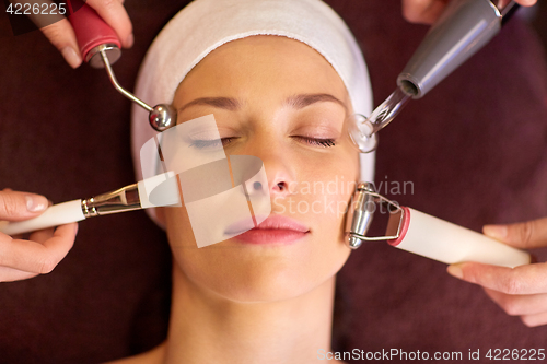 Image of woman having hydradermie facial treatment in spa