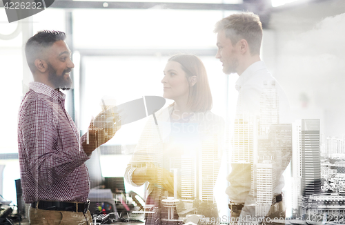 Image of happy business team drinking coffee at office