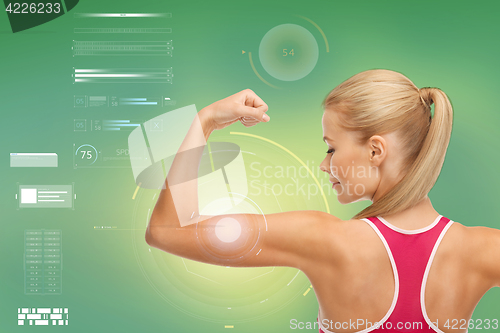 Image of happy sporty woman showing biceps