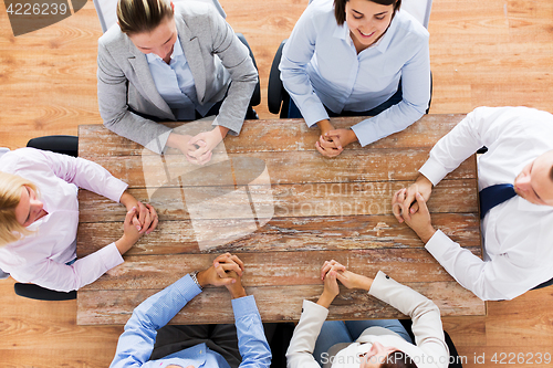Image of business people sitting at office table