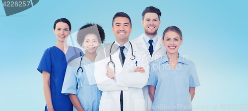Image of group of happy doctors over blue background