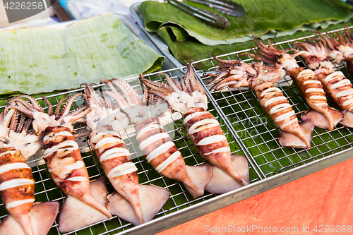 Image of squids on grill at street market
