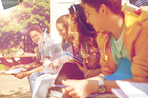 Image of group of students with notebooks at school yard