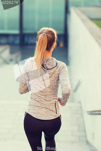 Image of close up of sporty woman running downstairs