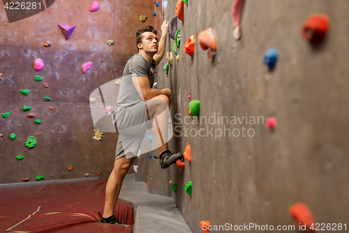 Image of young man exercising at indoor climbing gym