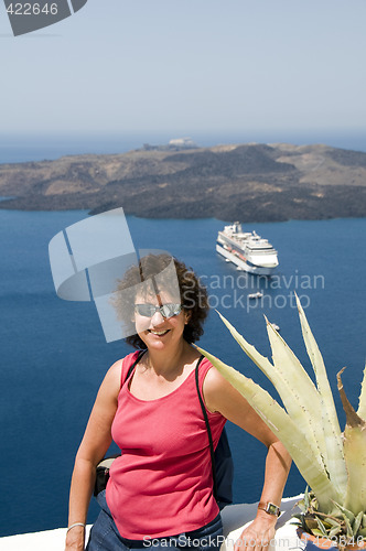 Image of smiling middle-age tourist in santorini greece