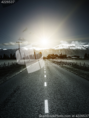 Image of road to the alps with dramatic sun light